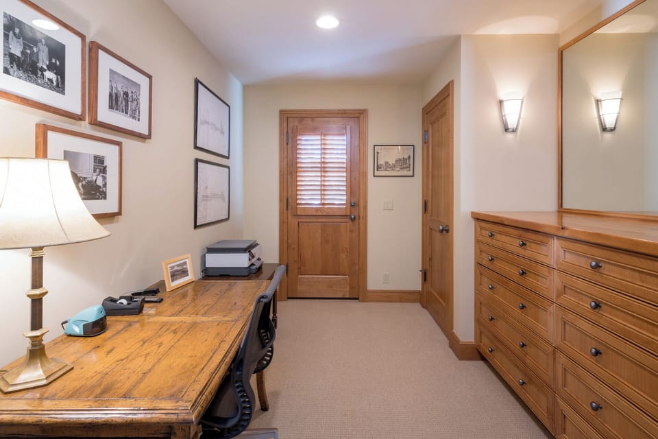Your private workspace awaits with a handcrafted wooden desk, vintage photography, and warm lighting—perfect for catching up on emails or planning adventures.