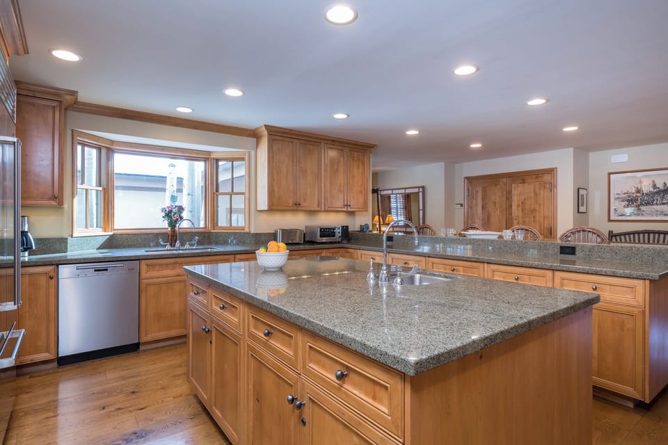 Your fully equipped kitchen features granite countertops, wood cabinetry, and modern appliances—perfect for creating memorable meals together.
