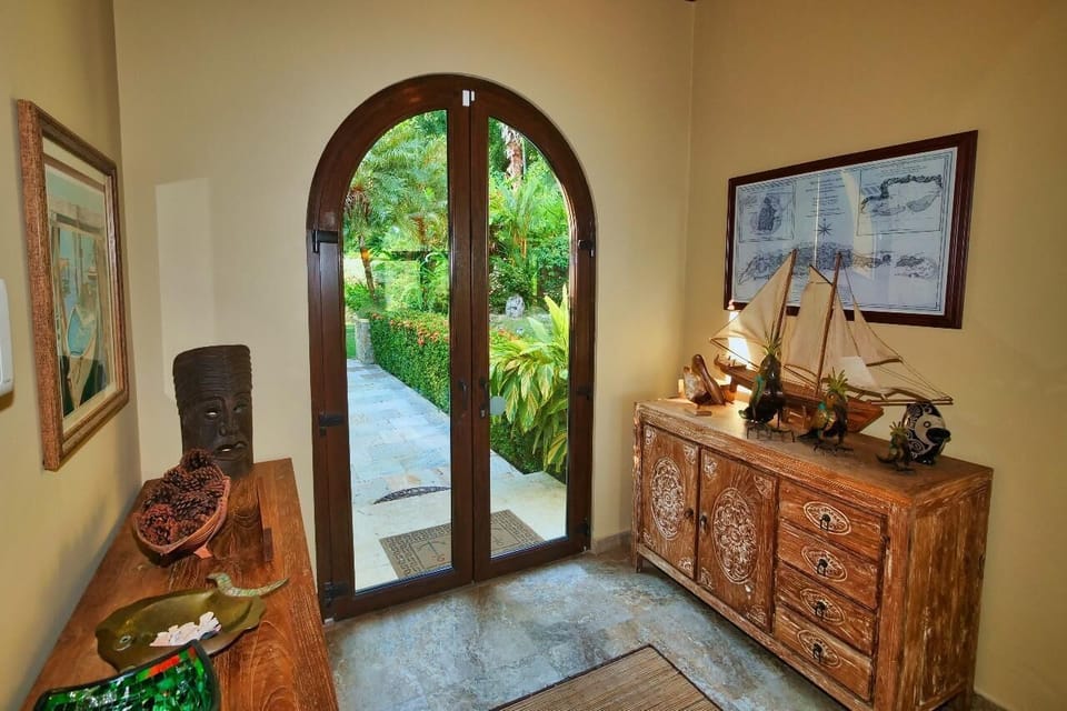 Welcoming entryway with charming wooden accents and garden views
