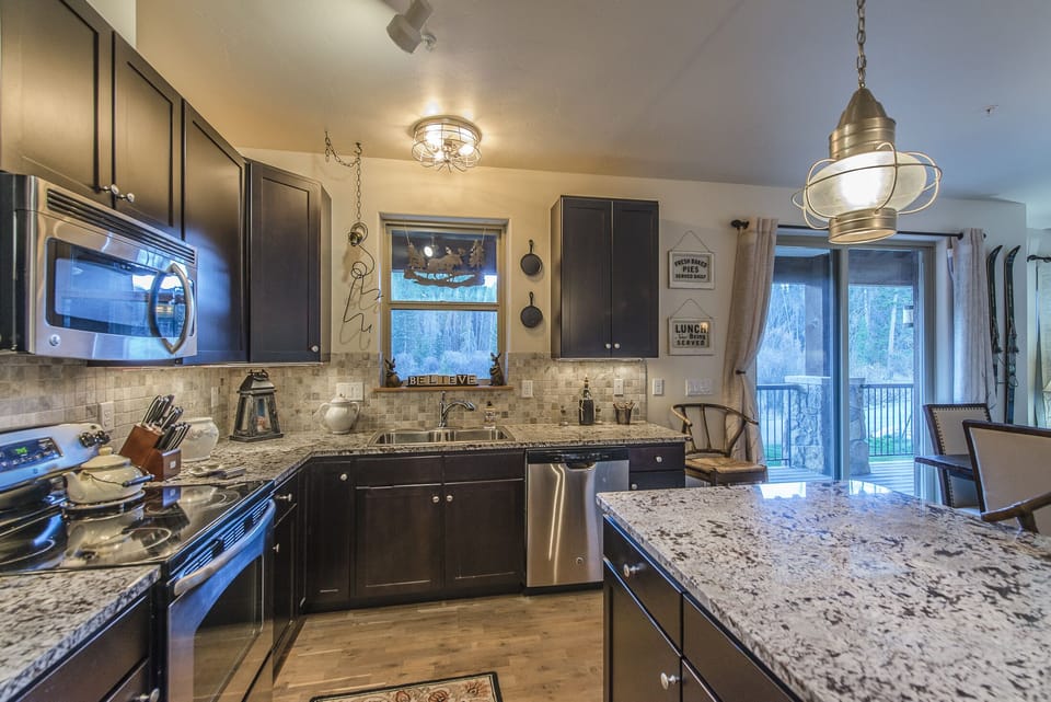 Kitchen - Kitchen-
Full size stainless steel appliances, hardwood flooring, and easy access to the private balcony for an outdoor dining option.