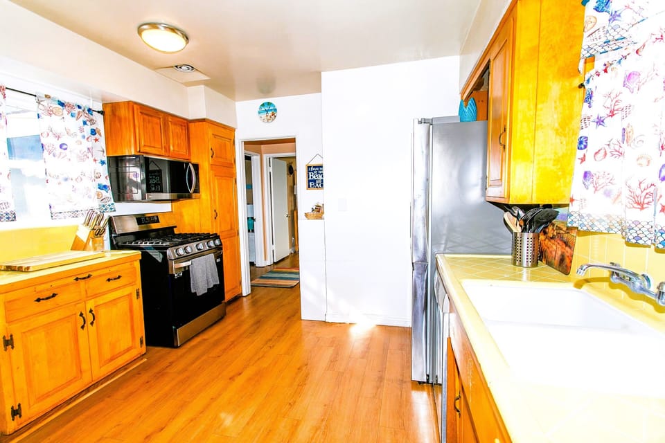 The kitchen features a 4-burner stove and microwave, perfect for preparing your favorite meals