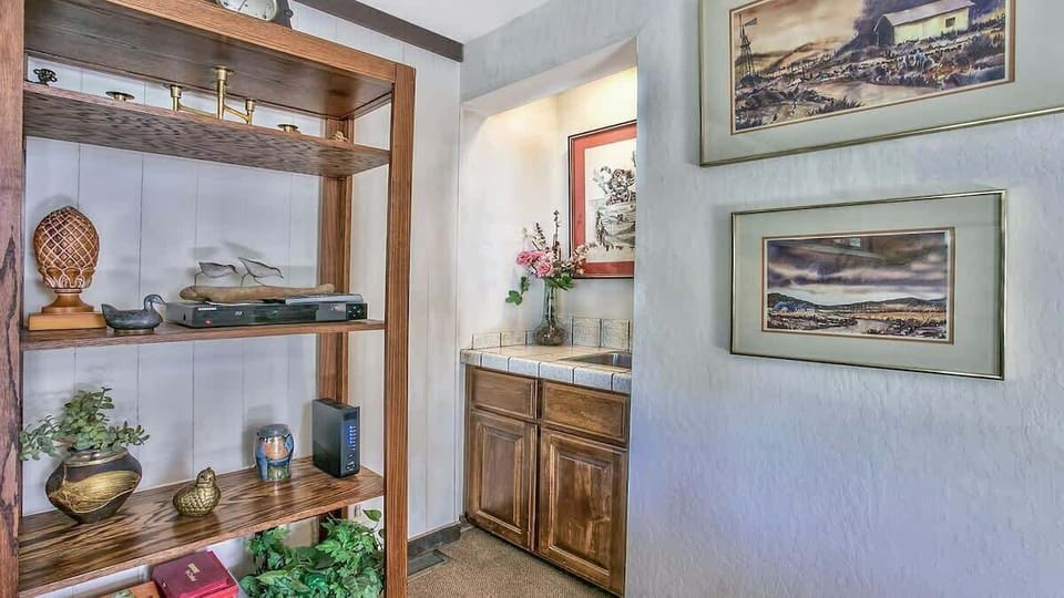 Stylish hallway space with display shelves and easy access to the bathroom vanity.