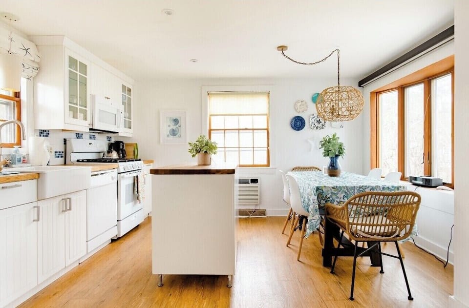 White beadboard cabinets with maple counters and an island. New appliances! 