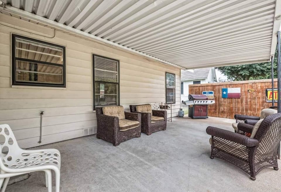 Covered back porch with gas grill and plenty of seating