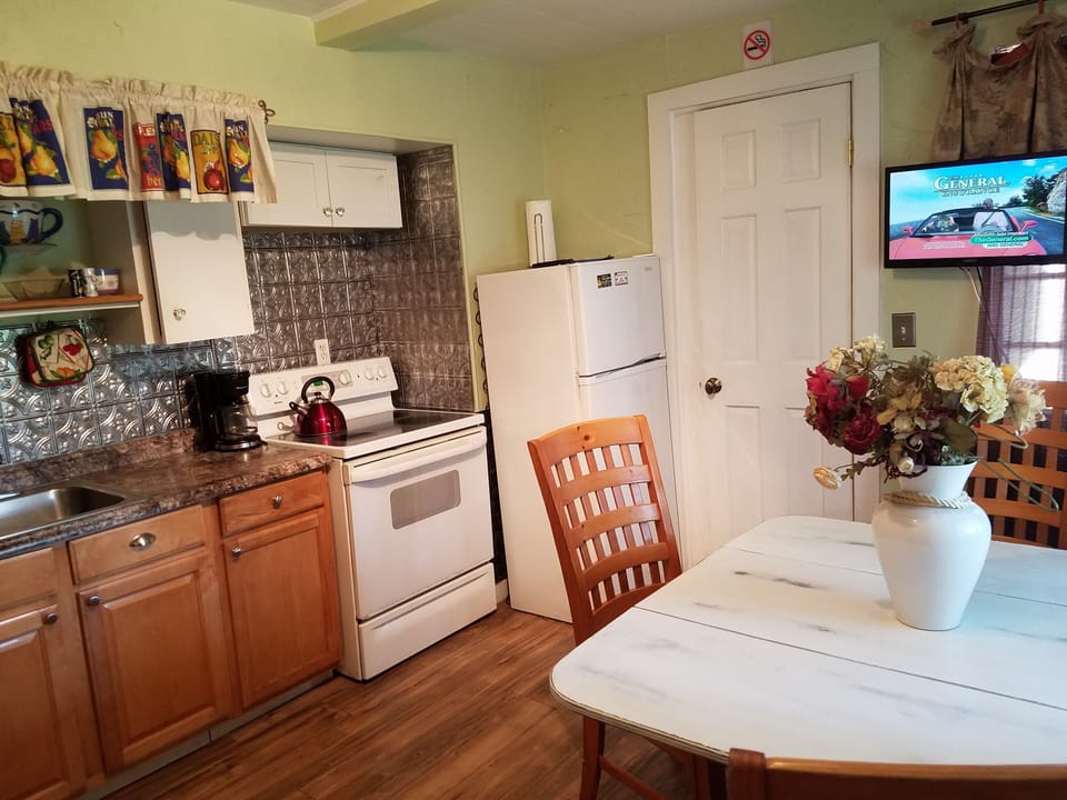 Combo kitchen/bedroom has door and lots of windows,.