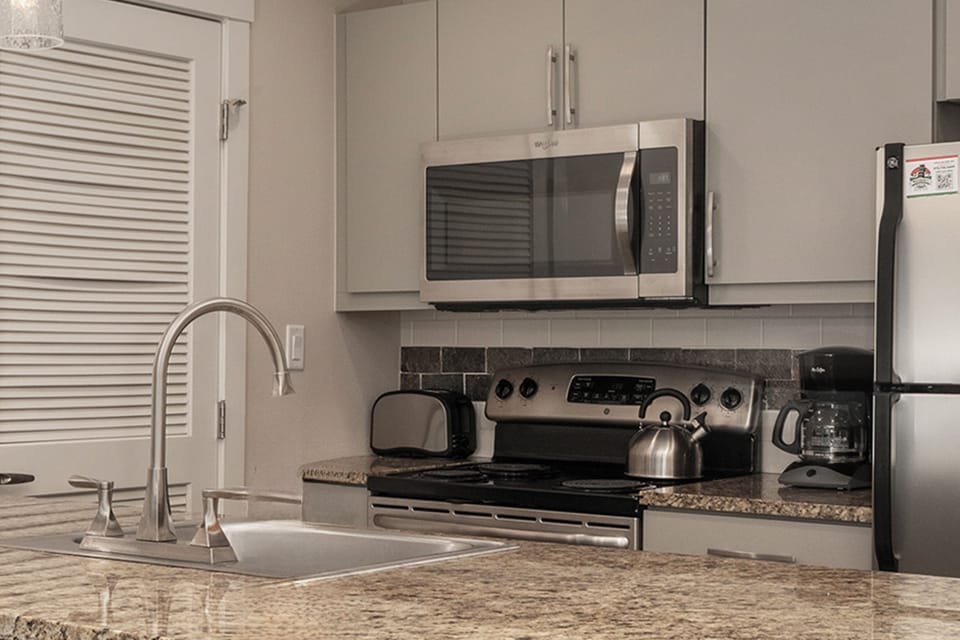 Kitchen with granite counter top and stainless steel appliances