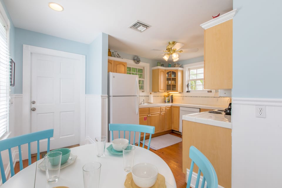 Door from kitchen leads to outdoor dining space and pool
