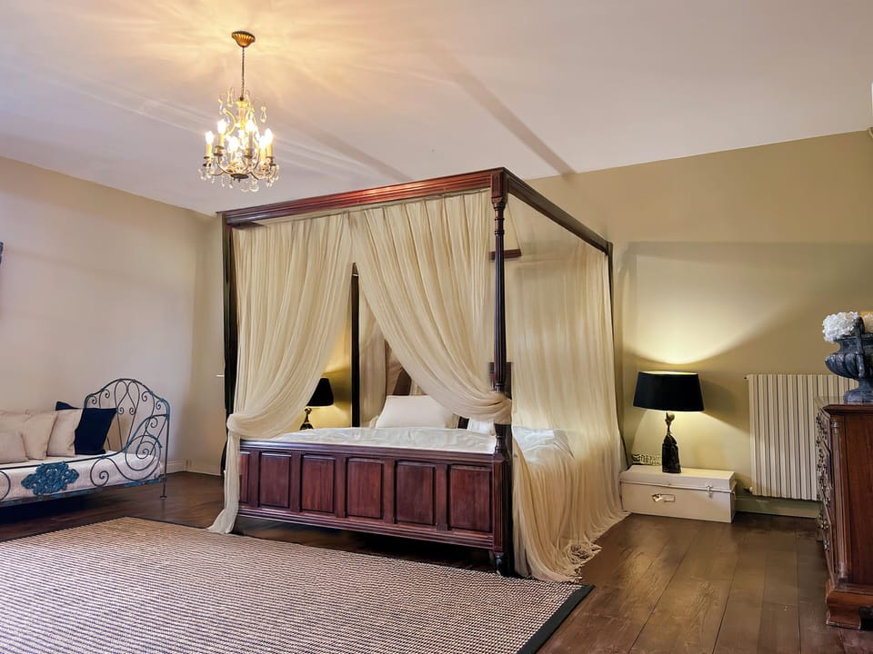 Elegant emperor-size bed in a classic style bedroom