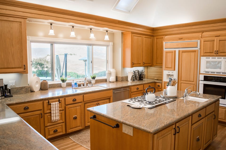 Large Kitchen with island. Granite tops, multiple sinks & breakfast bar!