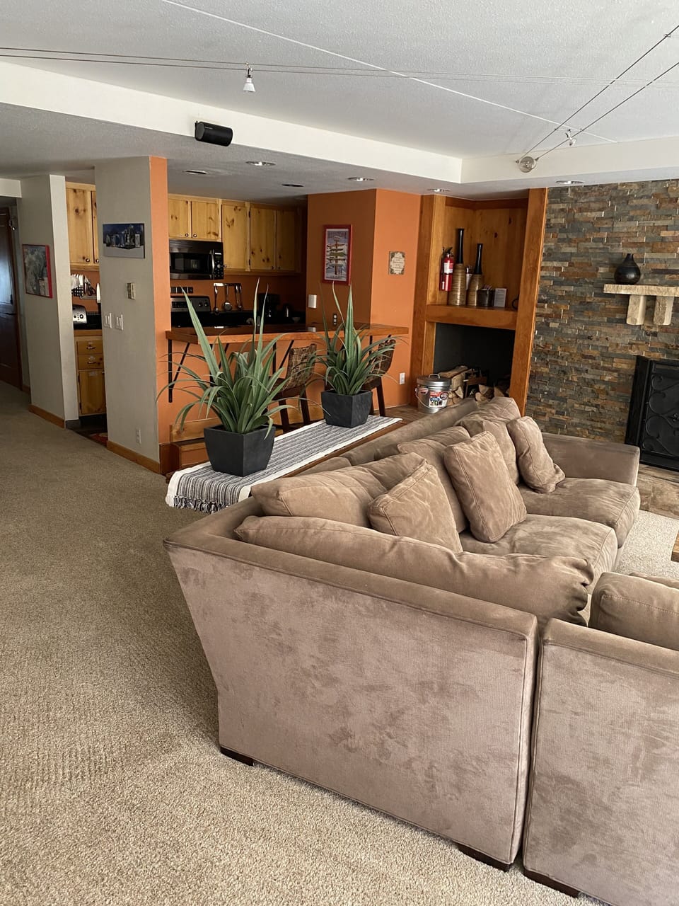 View from front room to kitchen and bar seating
