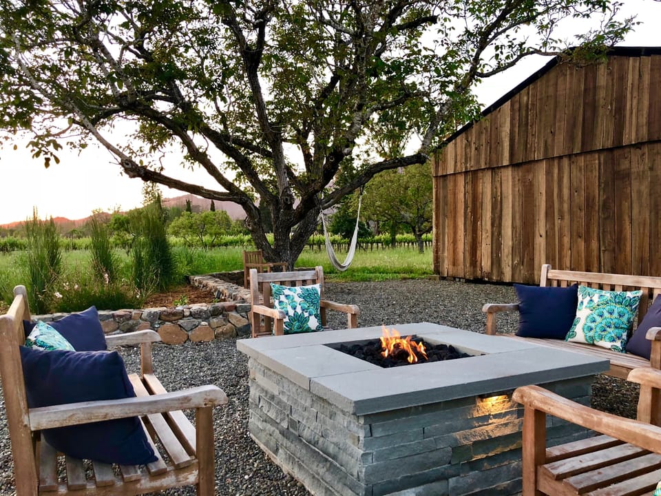 Sunset evenings in comfort at fire pit with view of barn & neighboring vineyards