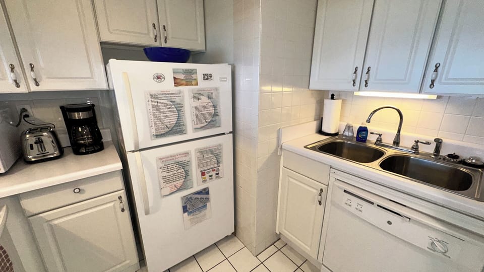 The kitchen has a toaster, coffee maker, fridge with an icemaker, & dishwasher.