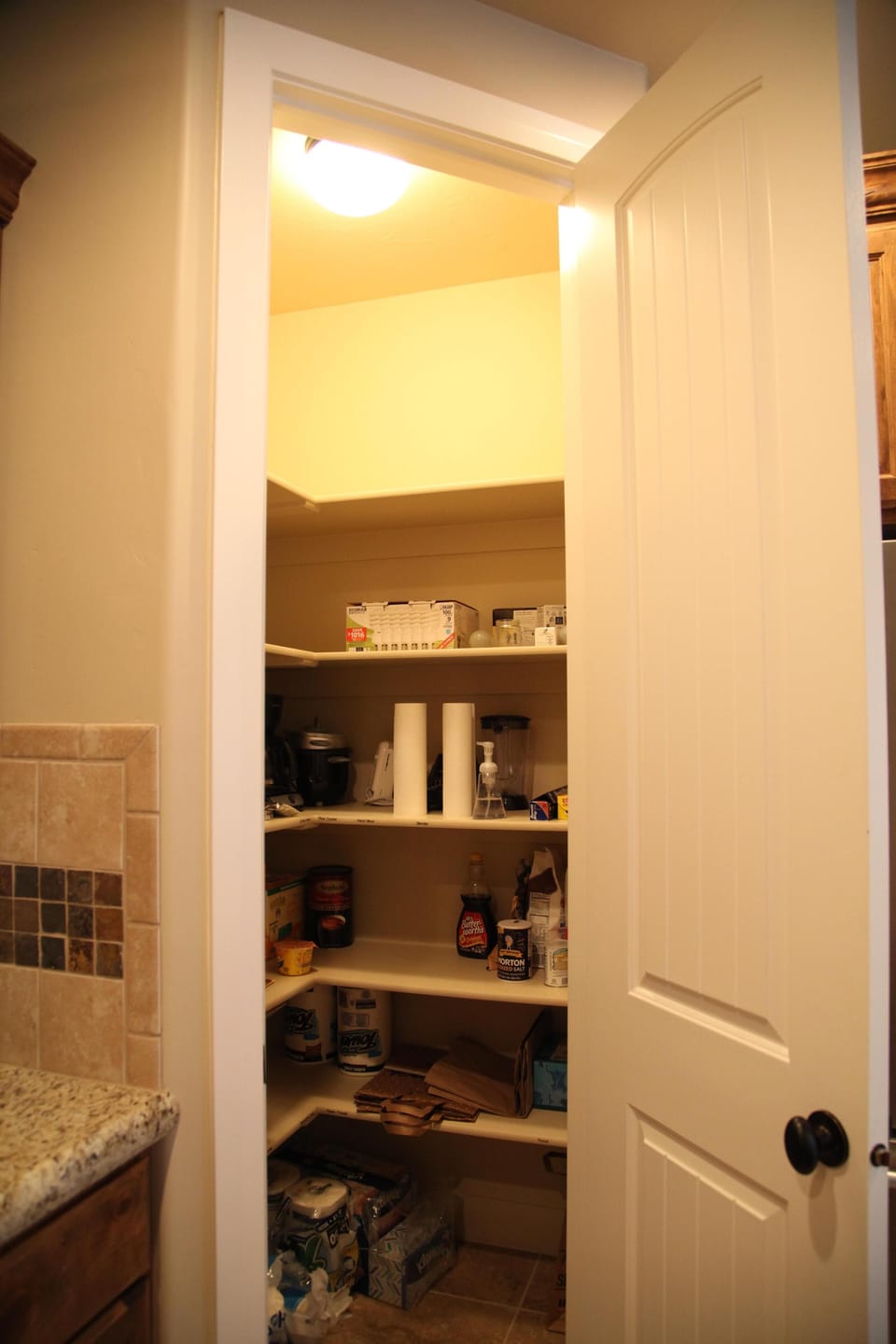 Well stocked kitchen with dishes, necessary small appliances, and condiments