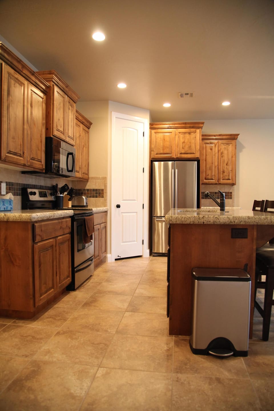Kitchen with stainless steel appliances, granite countertop, and maple cabinetry