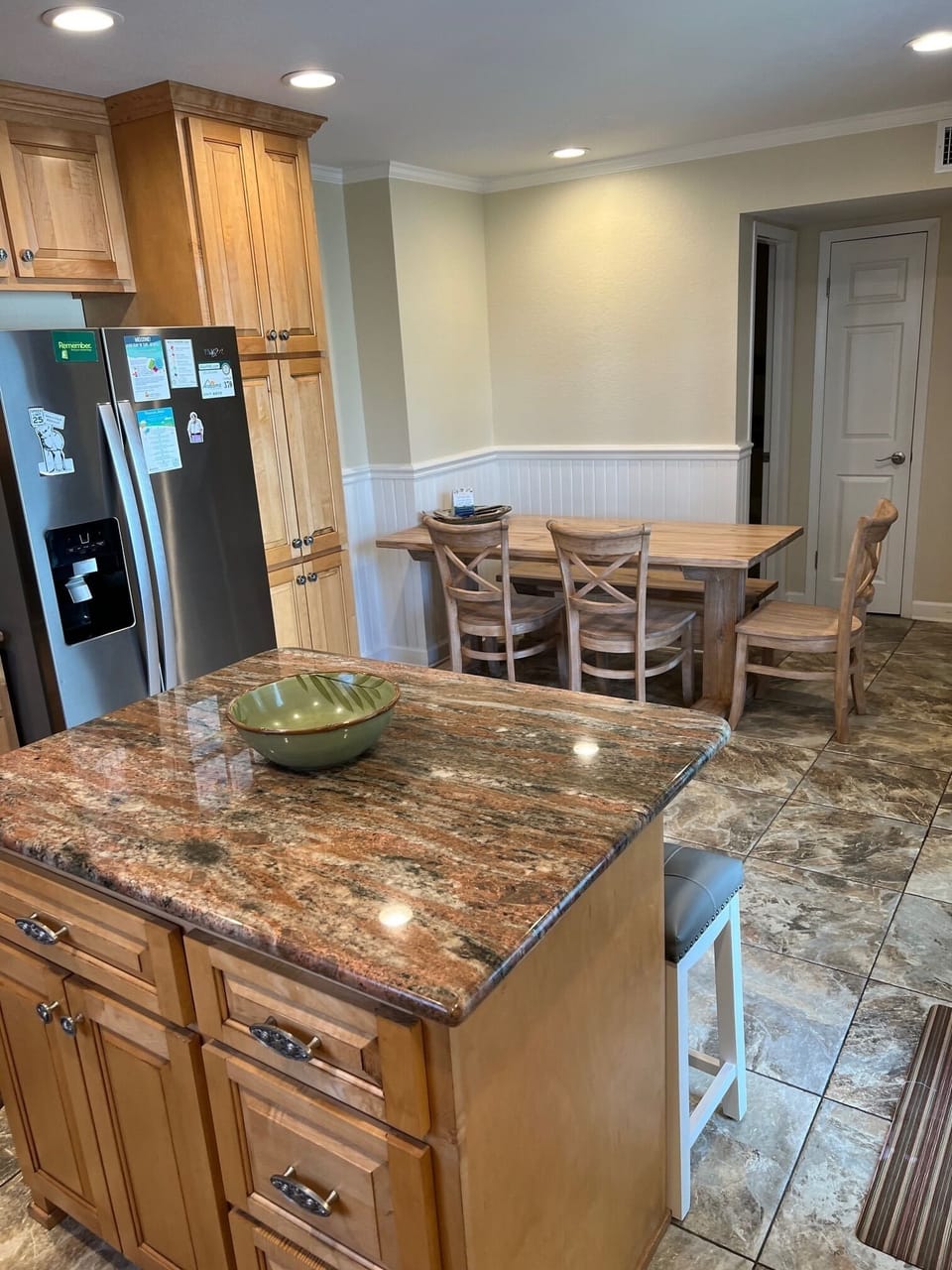 Kitchen table. Four chairs and a bench. Two bars stools at island. 