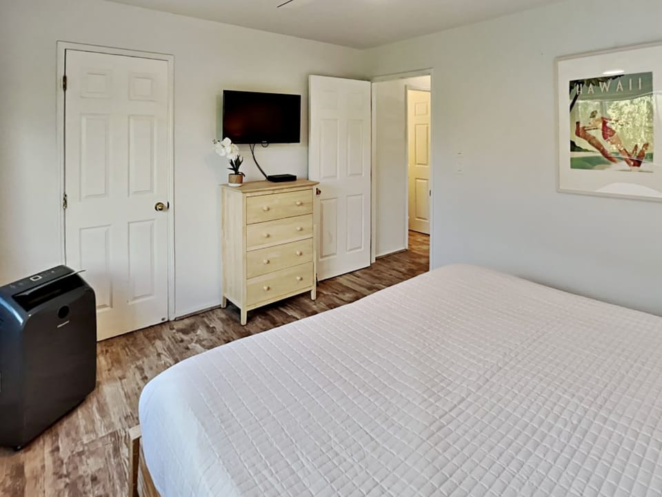 Drift off to sleep in this stylish bedroom while watching your favorite shows.