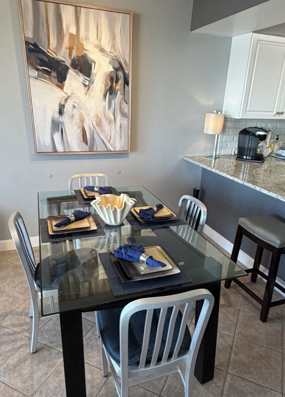 Lovely dining area w/ new feature artwork. Good workstation for your laptop too.