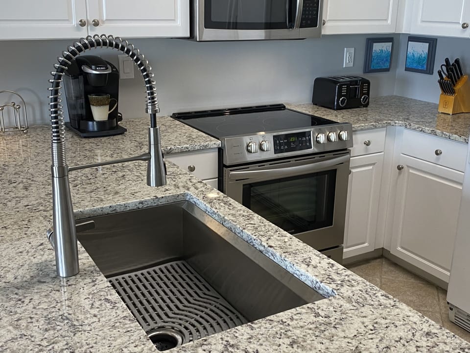 Kitchen updated in 2022 w/ all new countertops, Kohler sink/faucet & range.