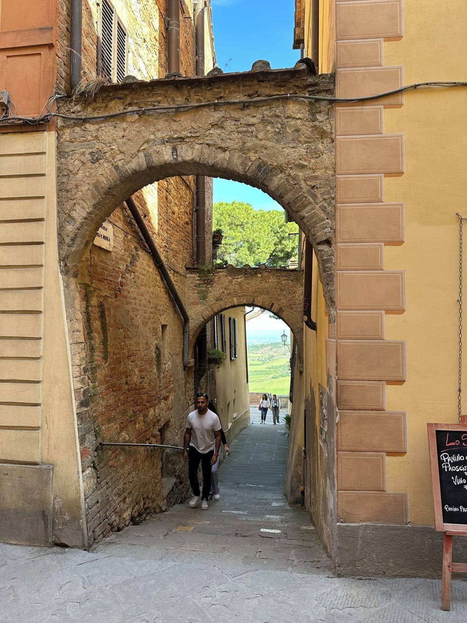 double arched laneway leads from the main street to the piazza