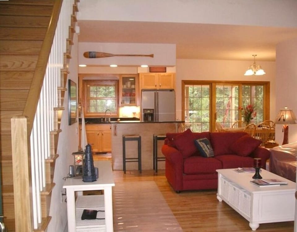 Great Room looking toward kitchen, dining & sliding doors to screened in porch.