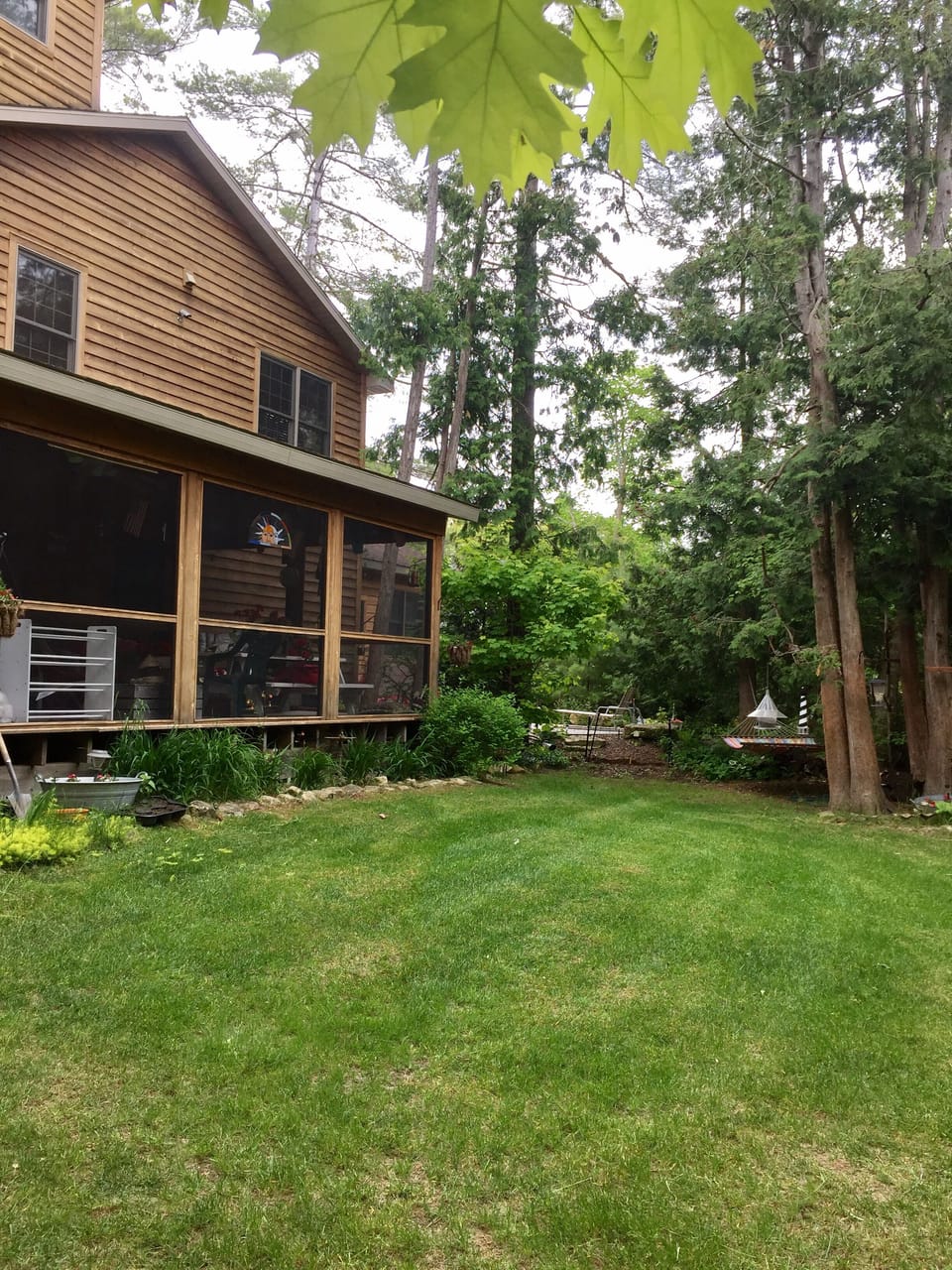 Large screened in porch with lots of cozy furniture and a picnic table!