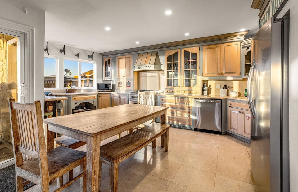 Bathed in natural light, this beautifully designed kitchen pairs premium appliances with warm wood finishes
                