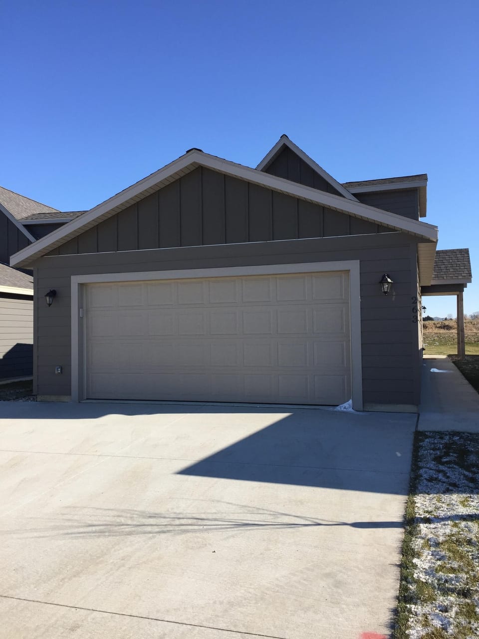 Exterior Front View of Double Car Garage and Large Driveway