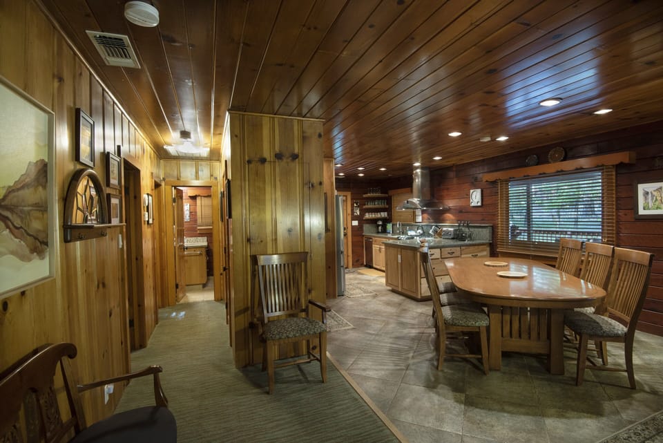 Reverse view of dining area in and kitchen in the background