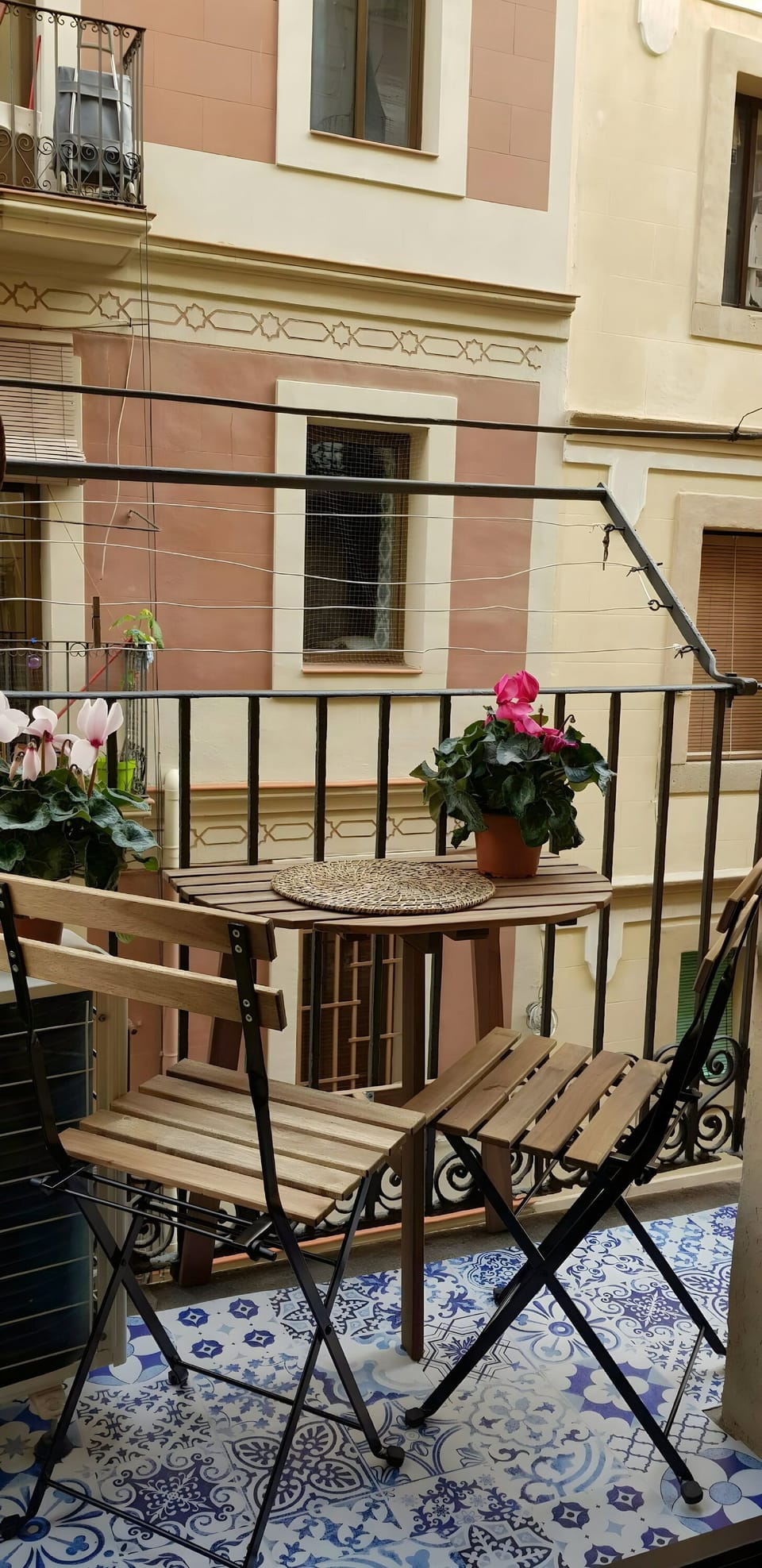Step out onto the charming balcony, adorned with vibrant patterned tiles and flowering plants. It's the perfect spot to enjoy your morning coffee.
