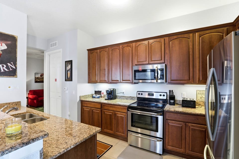 Modern kitchen with granite countertops and stainless-steel appliances.