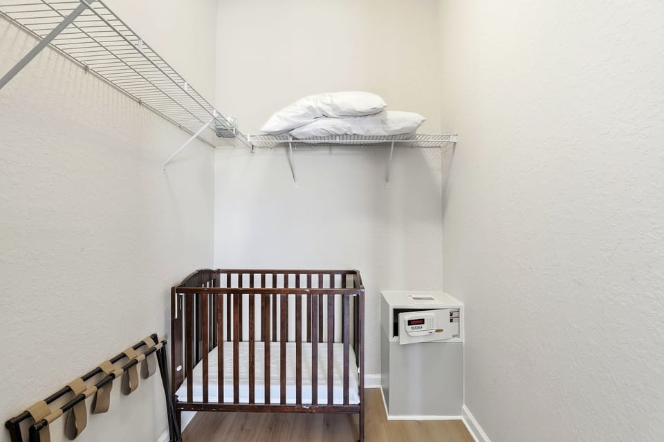 Crib and safe in primary bedroom closet.