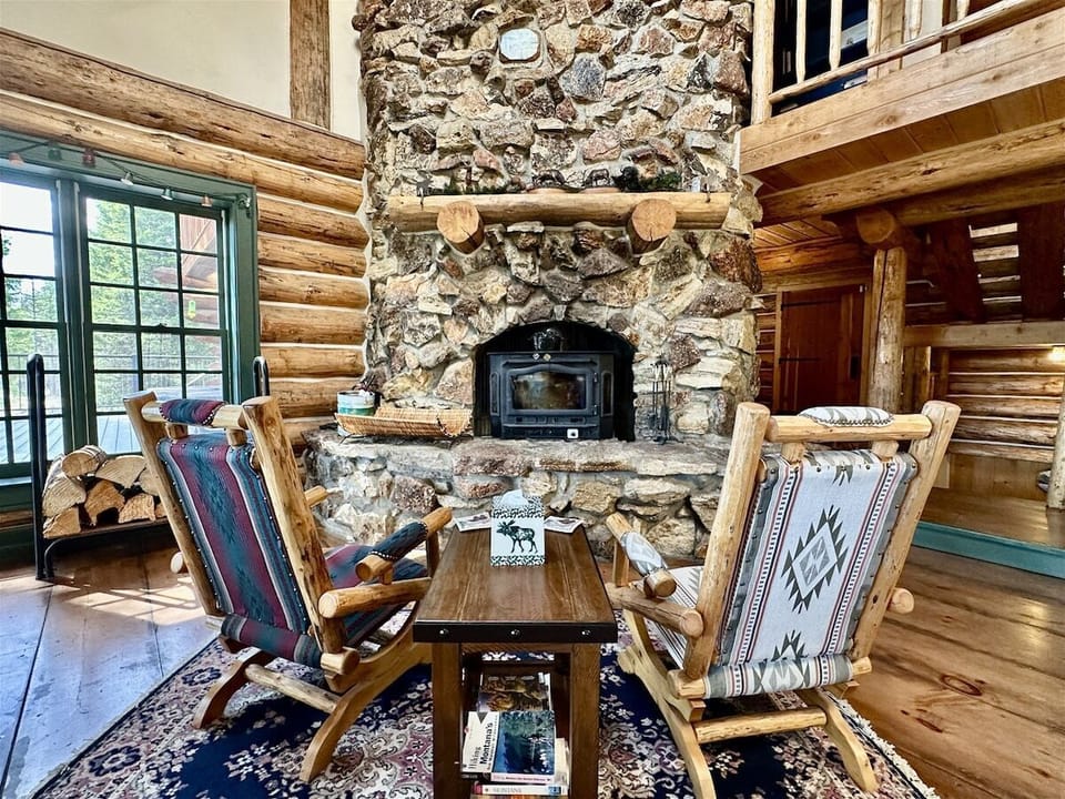 Grandiose wood burning fireplace, original to the home. Relined and adorned with existing rocks found around the property from a local company.