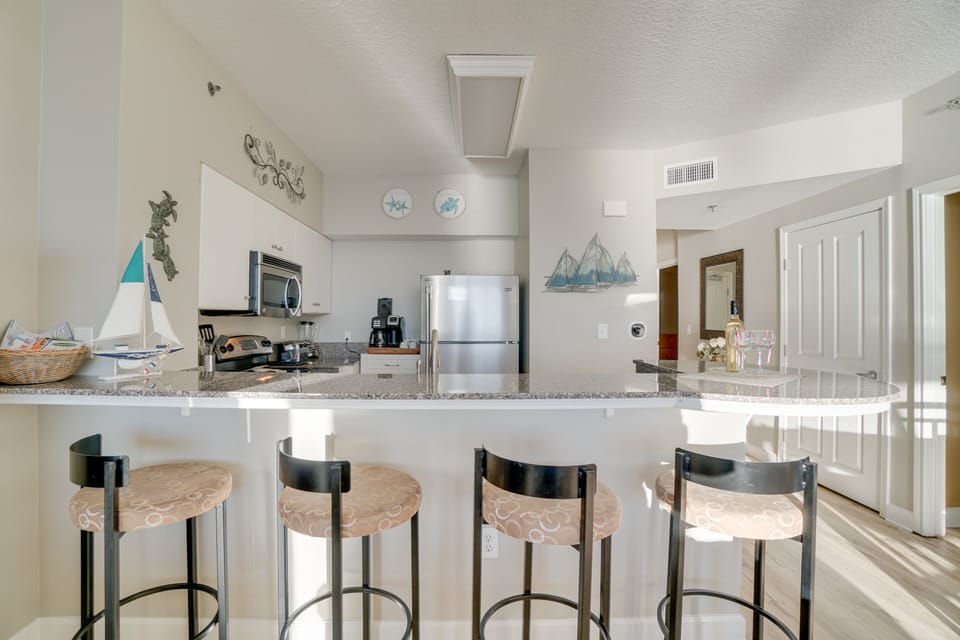 kitchen, stainless appliances, and stools