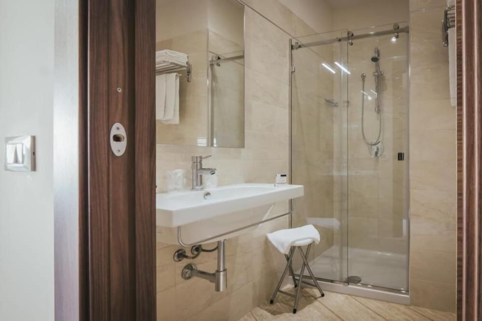 Shower, rainfall showerhead, designer toiletries, hair dryer