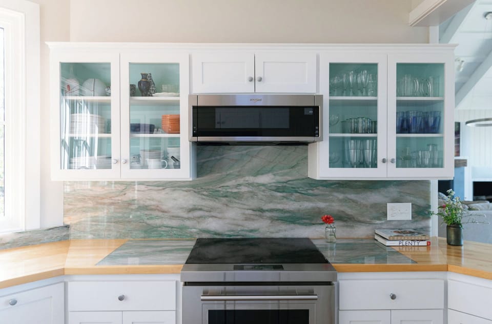 Kitchen with Wolf Induction Stove and Oven and stone backdrop.