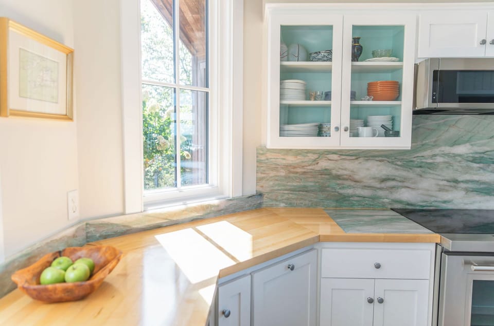 Kitchen view with stone backdrop.