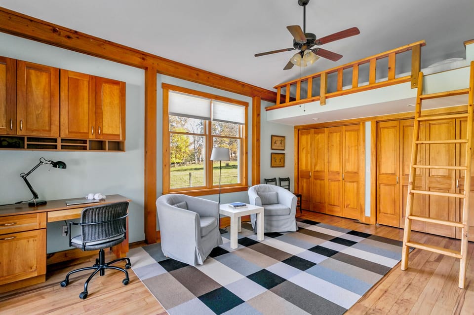 Sitting area, desk and sleeping loft in the main floor bedroom.