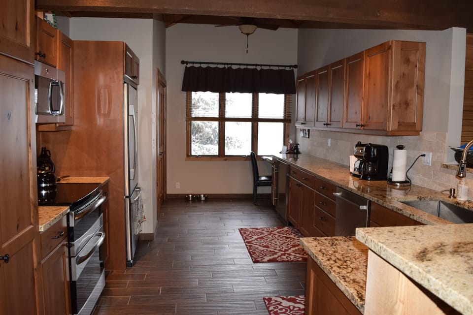 Spacious, well-stocked kitchen with heated floors and lots of counter space