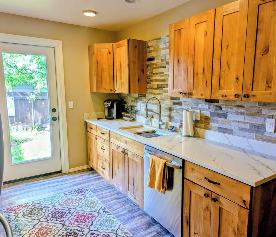 kitchen sink and dishwasher 
with door to yard.
