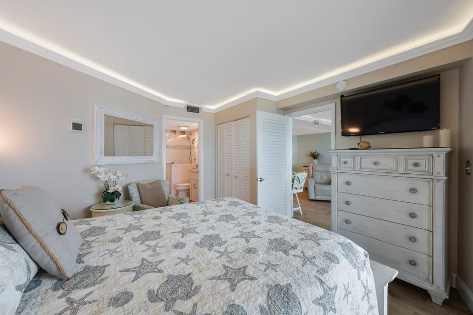 Master Bedroom with queen bed and view of master bathroom. 