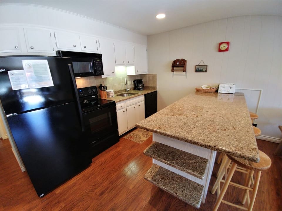 Your fully equipped kitchen invites you to whip up home-cooked meals with modern appliances, granite countertops, and a charming breakfast bar perfect for morning coffee.
