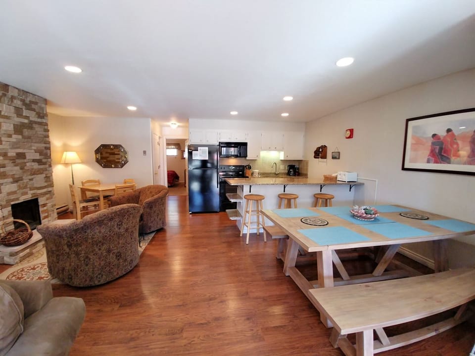 Your open-concept space blends comfort and function, with a warm fireplace, full kitchen, cozy seating, and a welcoming dining area to unwind and gather.