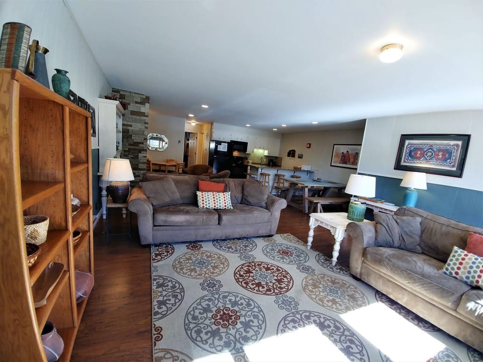 Sink into plush sofas in this inviting open-concept living space, where warm wood tones meet contemporary comfort. Your group will love gathering here to relax, share stories, and unwind together.