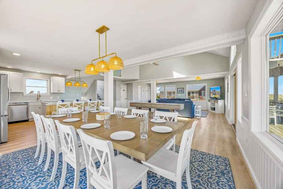 Gather around this spacious dining table where your group can share memorable meals together in this beautifully designed open-concept space.