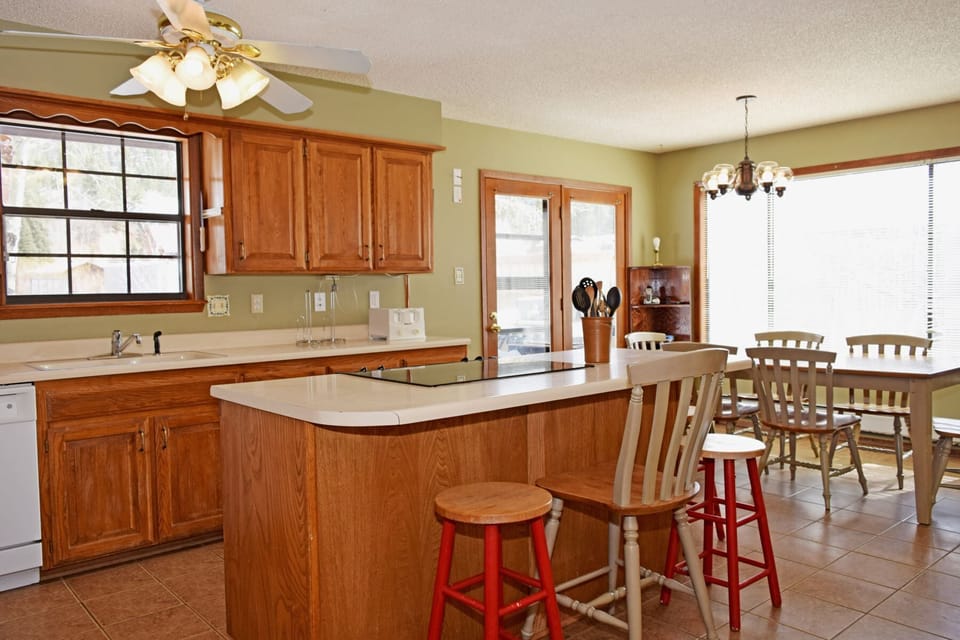 Your spacious kitchen flows into a bright dining area, perfect for preparing hearty breakfasts and gathering around the table with your group for memorable meals together.