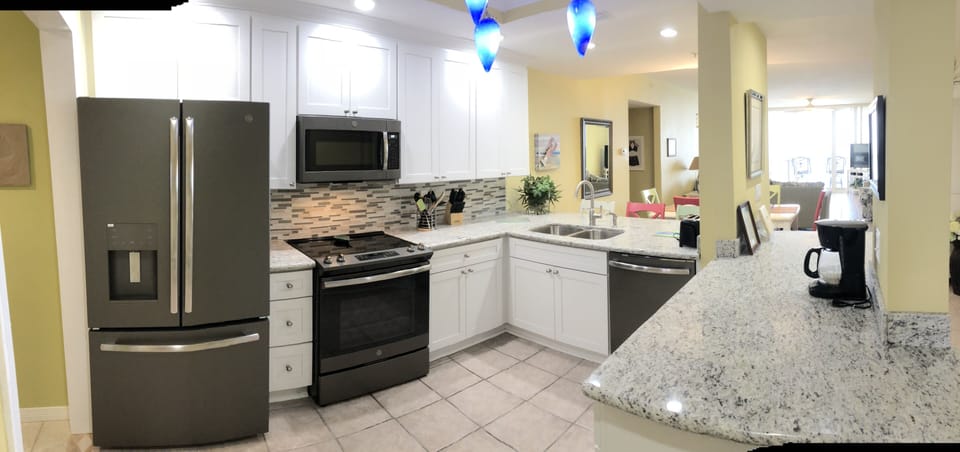 Large, beautiful kitchen with lots of counter space to serve many functions.