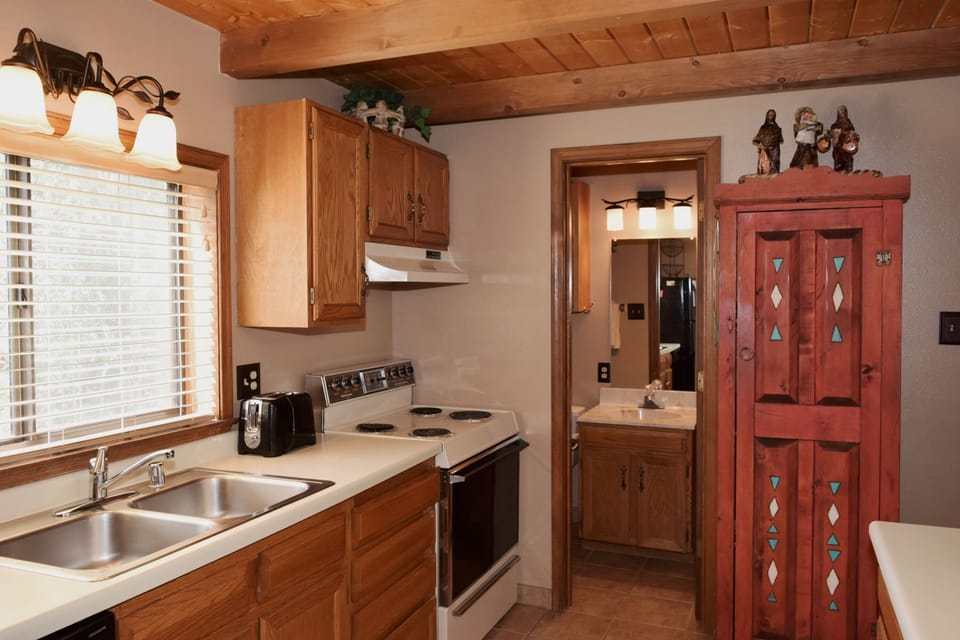 Your fully equipped kitchen features warm wood cabinetry and everything you need to prepare delicious home-cooked meals during your stay.