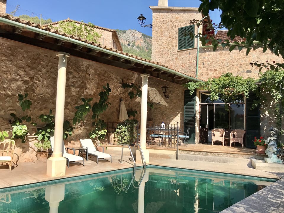 View of the dining terrace from pool lounge chair in the Autumn light.