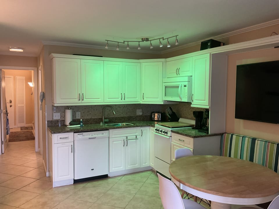 Fully equipped kitchen with dimmable color track lights.