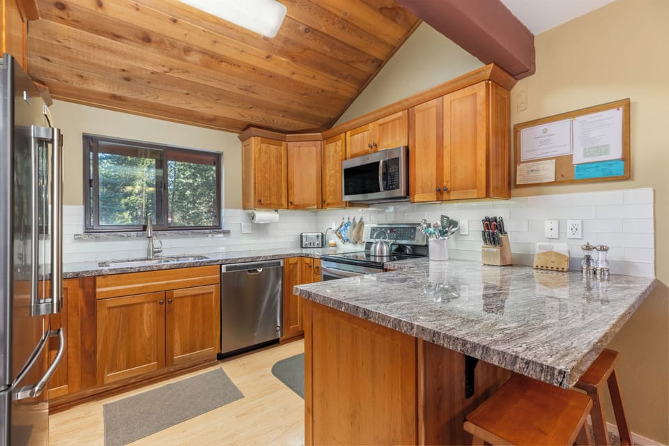 Remodeled kitchen with cherry cabinets, granite counters, and new appliances